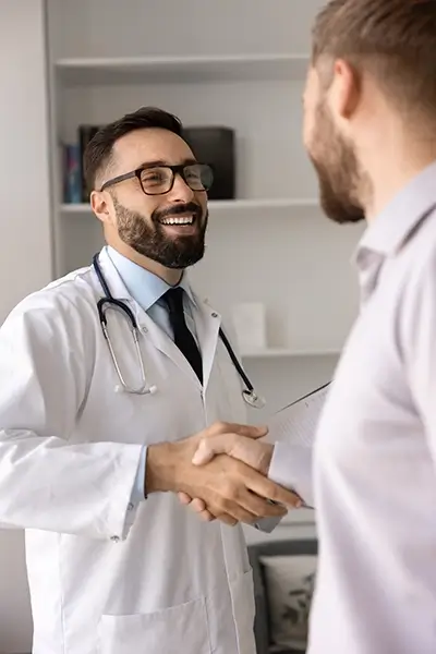 A doctor shaking hands with a patient