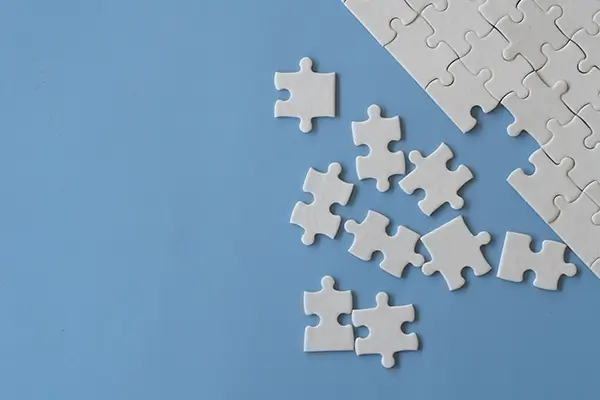 A puzzle with some pieces strewn about