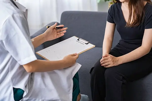 A doctor talking to a patient at a therapy session