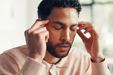 A map rubbing his temples