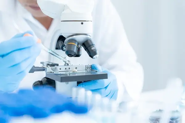 A scientist using a microscope