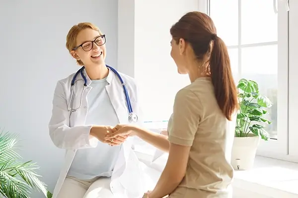 A friendly doctor shaking a patient's hand