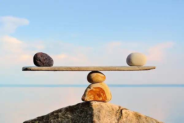 A balance scale made of rocks