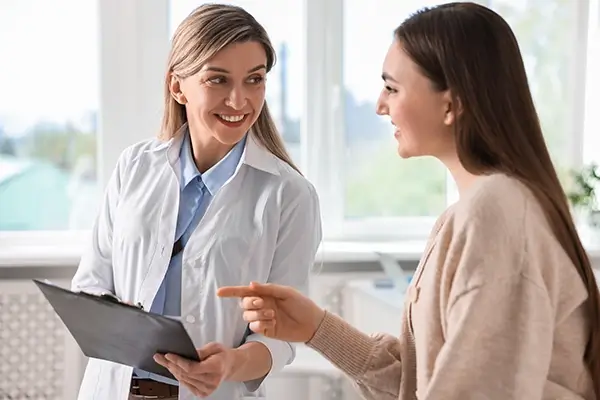 A friendly doctor showing results to a happy patient