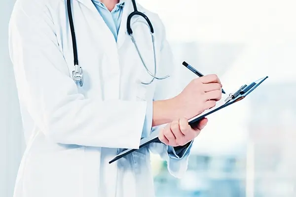 A doctor holding a clipboard and a pen