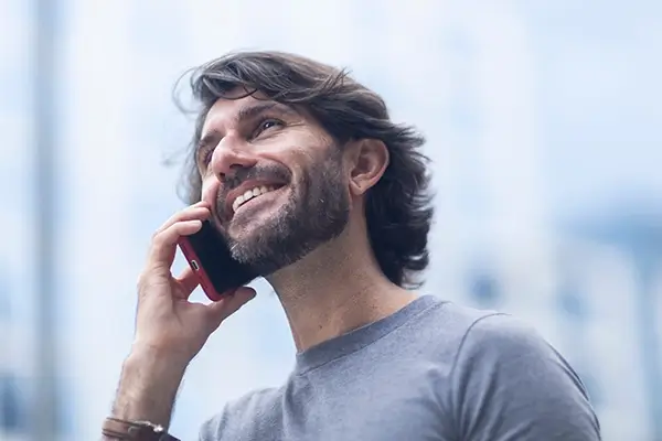 A man happily talking on the phone
