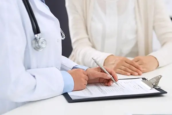 A doctor going over a clipboard with a patient